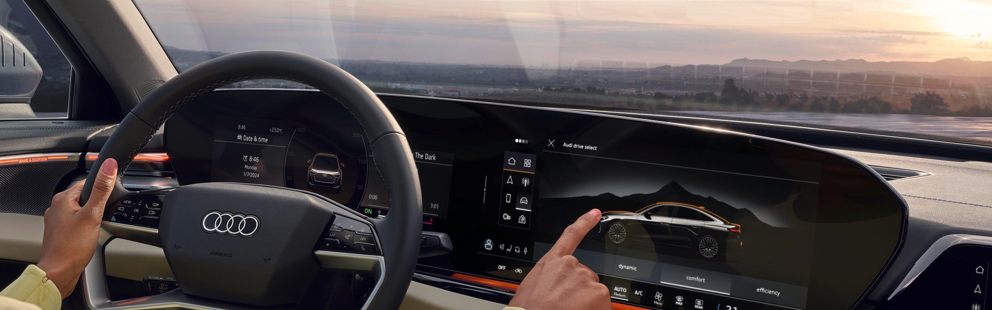 Interior Audi: tehnologie avansată, control intuitiv și peisaj spectaculos la apus.
