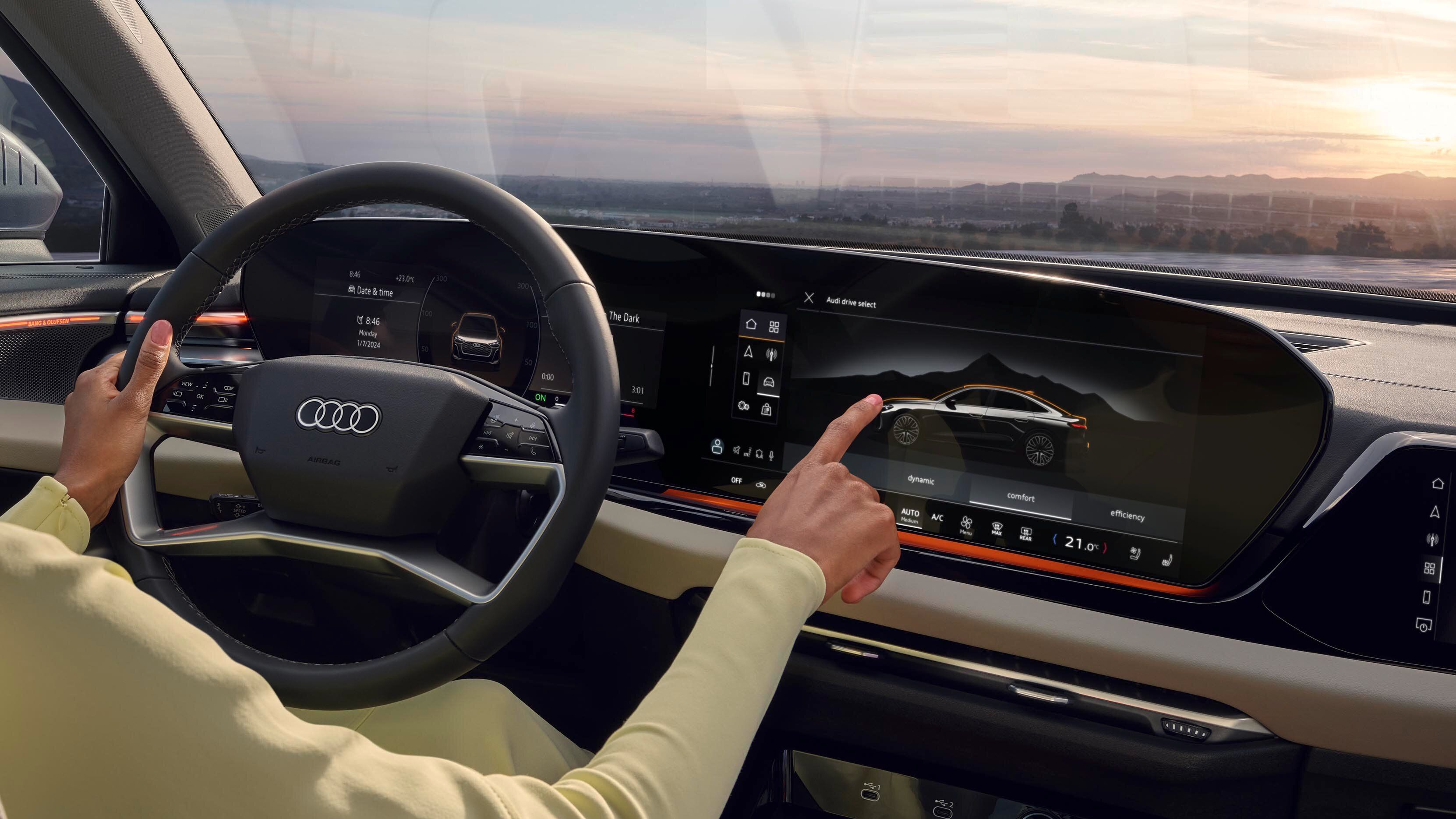 Interior Audi: tehnologie avansată, control intuitiv și peisaj spectaculos la apus.